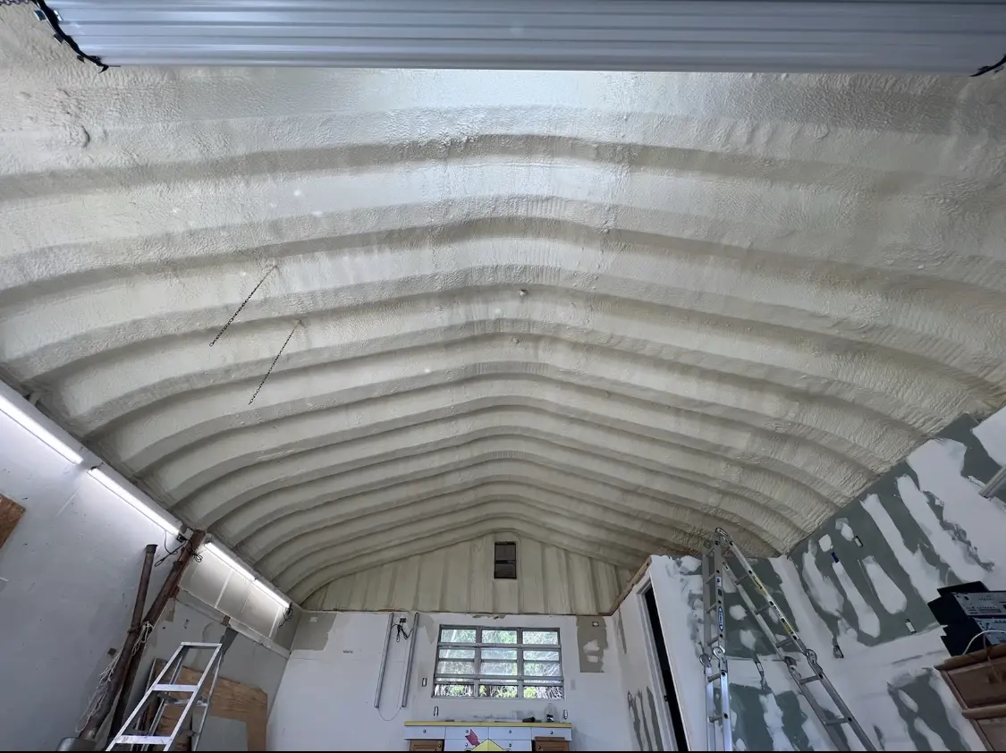 Spray polyurethane foam applied to the underside of a metal roof deck in Manchester
